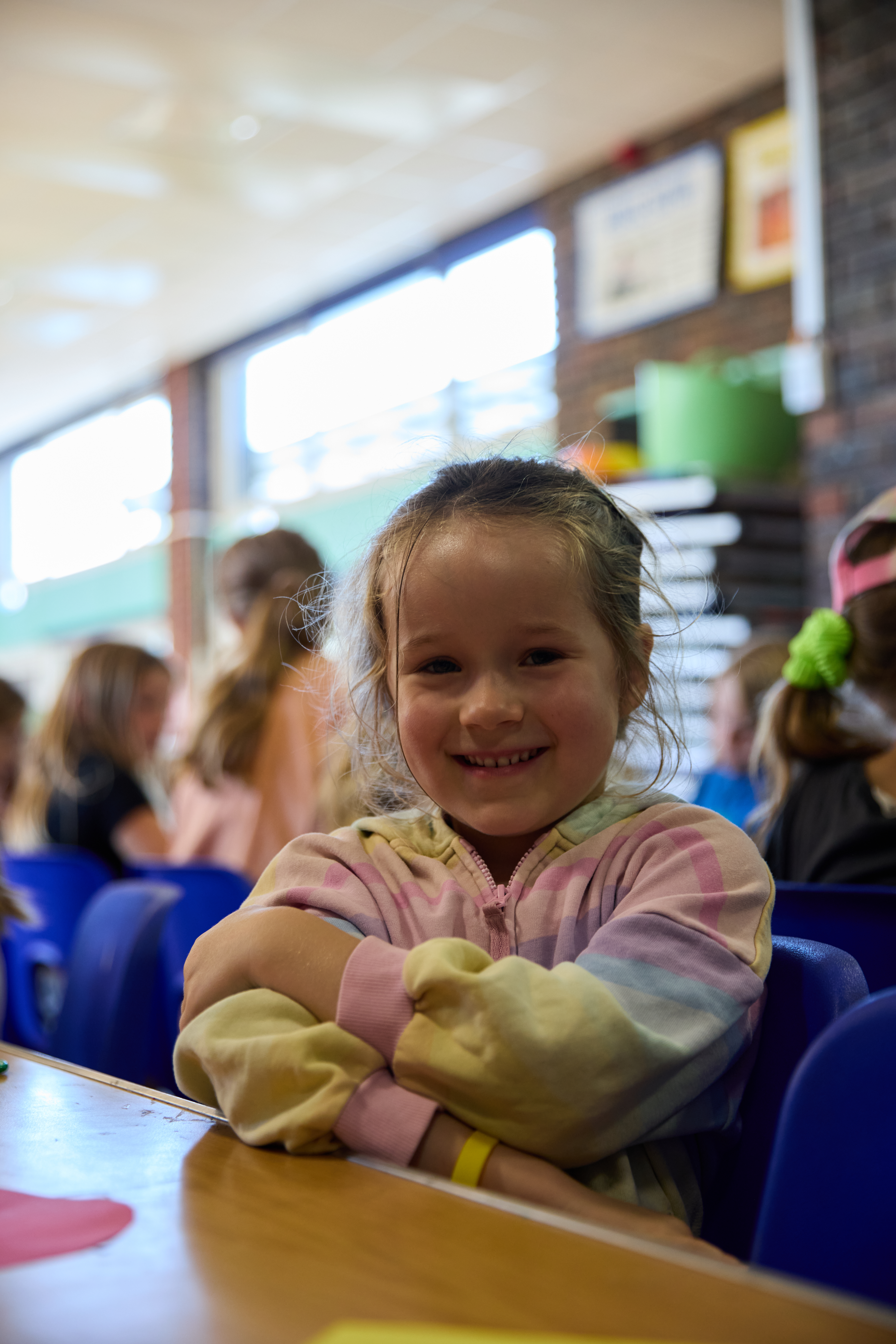 Young camper smiling at the table