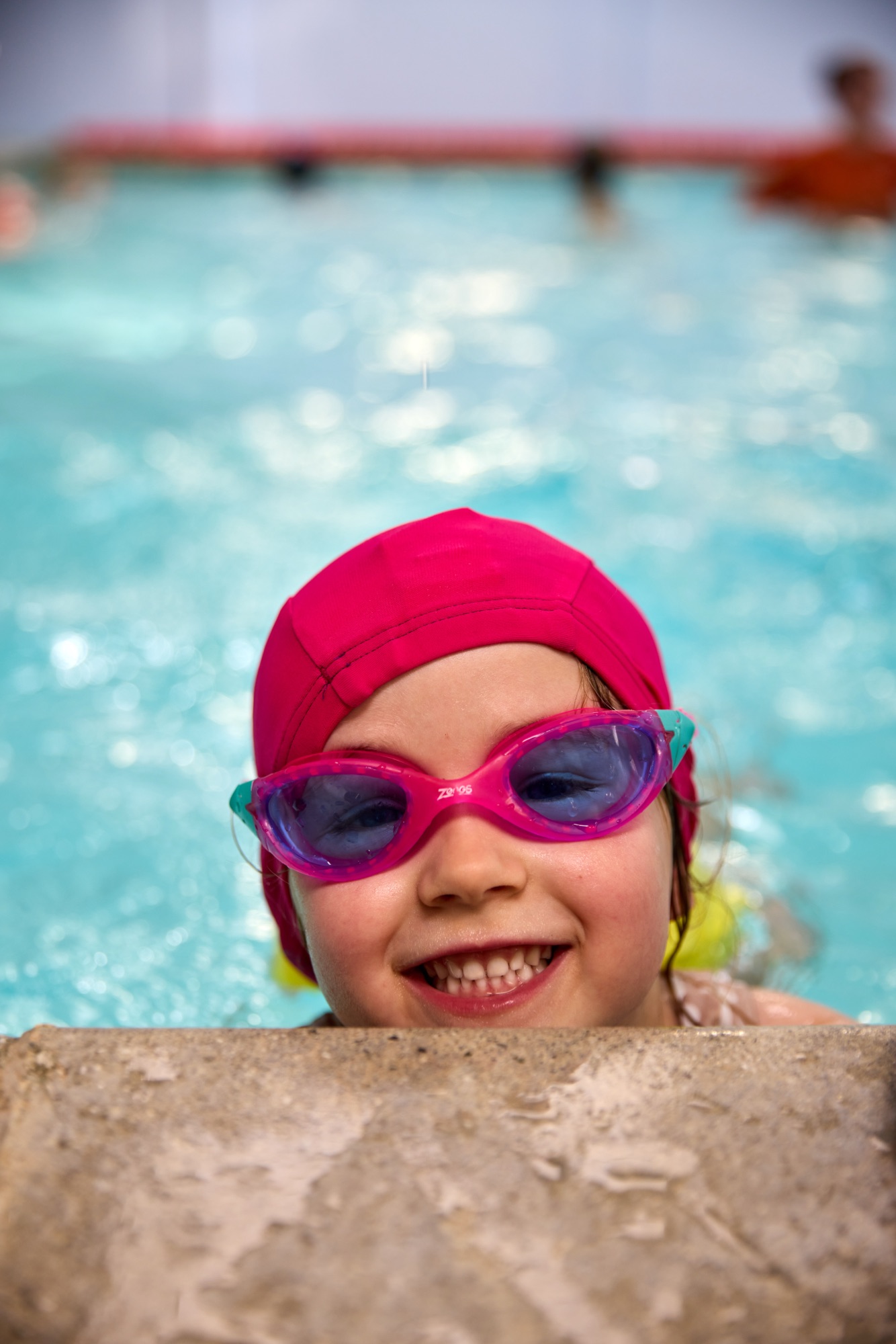 Young girl in swim goggles