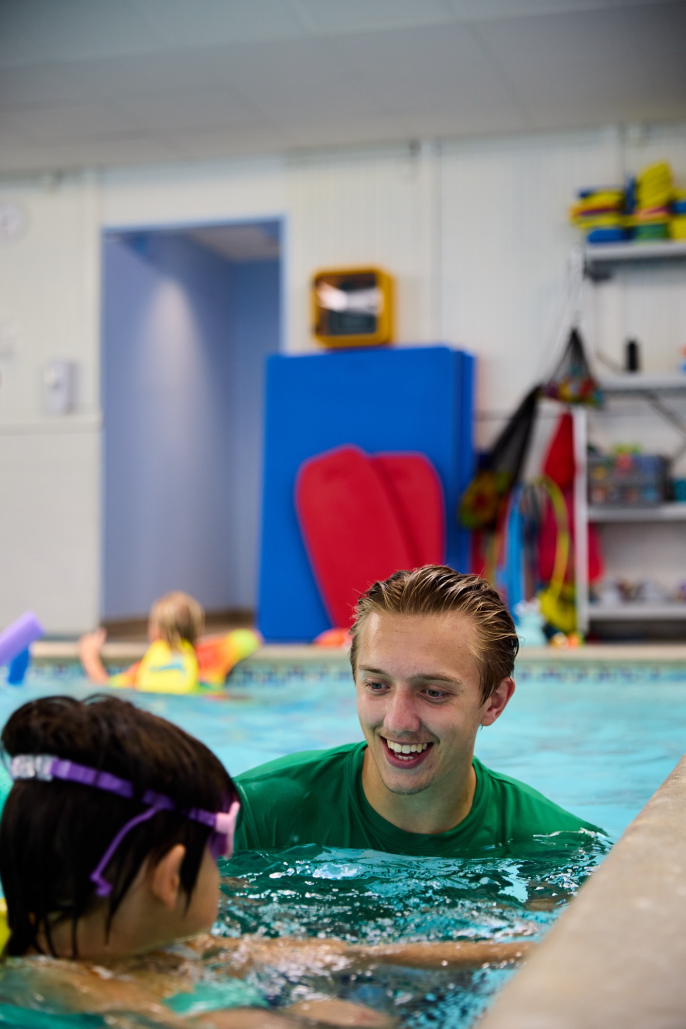 Instructor smiling with a young swimmer